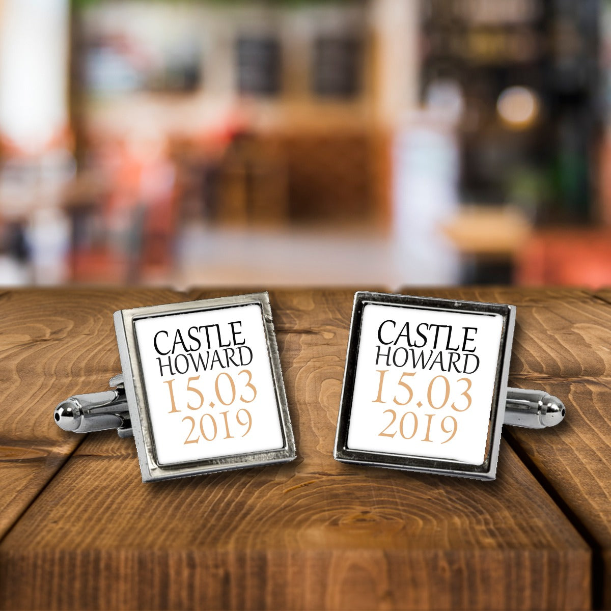 Personalised Wedding Venue & Date Cufflinks – Wedding Gift for Him – White or Black Print, Chrome or Rose Gold – Personalised Wedding Venue & Date cufflinks, a chrome square pair with white print on a wooden bar table