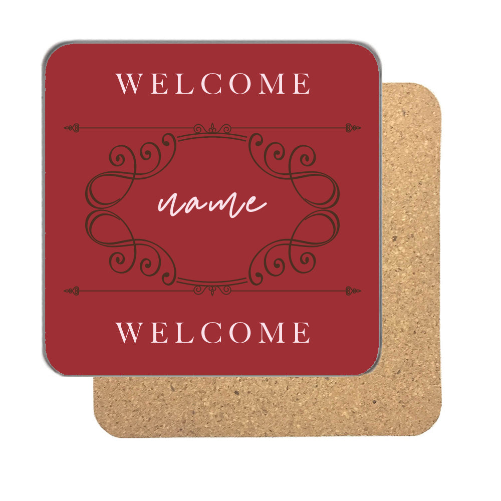 Personalised burgundy welcome coaster with a name in pale pink script inside an ornate frame between Welcome lines