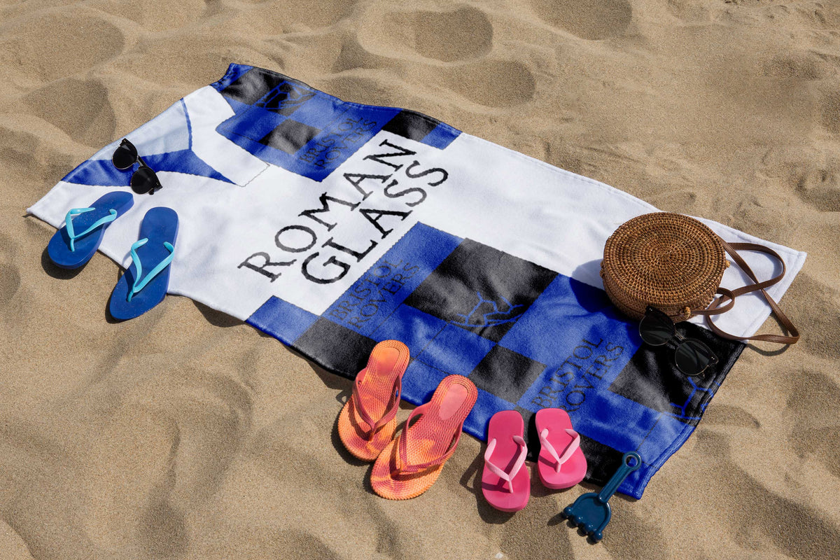 Bristol Rovers 1995 Retro Football Lightweight Beach Gym Towel – Bristol Rovers 1995 retro football lightweight beach gym towel laid out on the sand