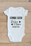 Baby coming soon baby grow showing the printed design on the front