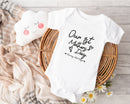 Personalised first Mother's Day baby grow with Our 1st Mother's Day design in black, printed with baby's name