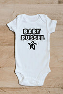Baby family name star baby grow showing the printed design on the front