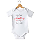 Flat mockup of the My First Valentine's Day design on a short-sleeve baby vest