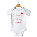 Flat mockup of the First Valentine Is Mummy name design on a short-sleeve baby vest