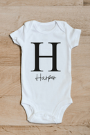 Initial and name baby grow showing the printed design on the front