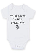 Flat mockup of the You're Going To Be A Daddy design on a short-sleeve baby vest