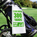 Funny golf towel printed with I can drive 300 yards in my cart, clipped to a golf bag