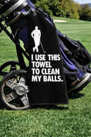 Cheeky golf towel reading I use this towel to clean my balls, design 2, on a golf bag