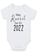 Flat mockup of the pregnancy announcement design on a short-sleeve baby vest