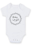 Flat mockup of the baby surname flower wheel design on a short-sleeve baby vest