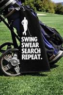 Swing Swear Search Repeat golf towel clipped to a golf bag