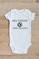 New signing baby grow with surname showing the printed design on the front