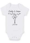 Flat mockup of the Daddy and baby first Father's Day design on a short-sleeve baby vest