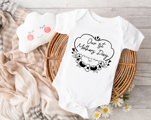 Personalised first Mother's Day baby grow with Our 1st Mother's Day Flowers design in black, printed with baby's name