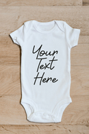 Custom text baby grow showing the printed design on the front