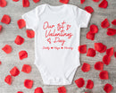 Our First Valentine's Day family baby grow showing the printed design on the front