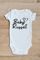 Baby family name heart baby grow showing the printed design on the front