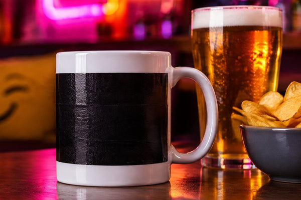 Rude adult mugs banner: a censored mug with a pint and crisps in a pub