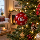 Personalised name bauble hanging on a Christmas tree with fairy lights
