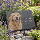 Personalised pet memorial slate plaque in a garden flower bed among lavender