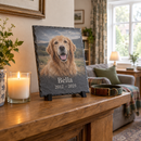 Personalised pet memorial slate plaque on a mantelpiece beside a candle and dog collar