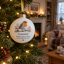 Memorial robin bauble hanging on a Christmas tree with fairy lights