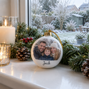 Personalised photo bauble on a windowsill with a pine garland and candles
