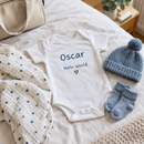 Personalised baby vest with the name Oscar packed for a newborn's going-home outfit