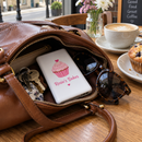 Personalised power bank in a handbag on a café table