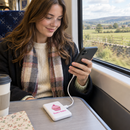 Personalised power bank charging a phone on a train