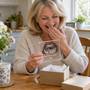 Grandparent opening a personalised pregnancy announcement plaque gift