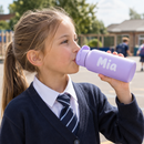 Child drinking from a personalised kids school water bottle with the name Mia