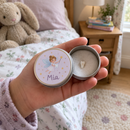 Personalised tooth fairy tin with the name Mia held open by a child in a bedroom