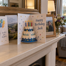 Personalised pop-up 3D birthday card standing open on a mantelpiece among birthday cards