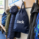 Personalised drawstring PE bag hanging on a school cloakroom peg