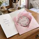 Personalised compact mirror as a birthday gift on a dressing table