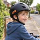 Child wearing a bike helmet with personalised helmet name decals reading Alfie