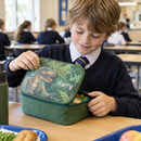 Child opening a personalised kids lunch box with the name Harry at school