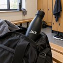 Personalised stainless steel water bottle with the name Jack in a gym bag