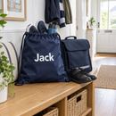 Personalised drawstring PE bag packed with trainers on a hallway bench