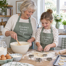 Grandmother and granddaughter baking in matching personalised aprons