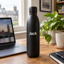 Personalised stainless steel water bottle with the name Jack on an office desk