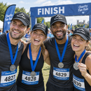 Friends at a charity fun run wearing matching personalised caps