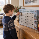 Child opening the first drawer of a personalised advent calendar