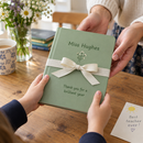 Child giving a personalised A5 notebook as an end of term teacher gift