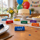 Custom printed building bricks as party favours on a birthday table