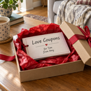 Personalised love coupon book in a gift box with red tissue paper