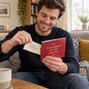 Man tearing a coupon from a personalised love coupon book