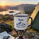 Personalised enamel camping mug with the name Tom beside a tent at sunrise