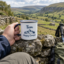 Personalised enamel camping mug with the name Tom held by a walker on a dry stone wall